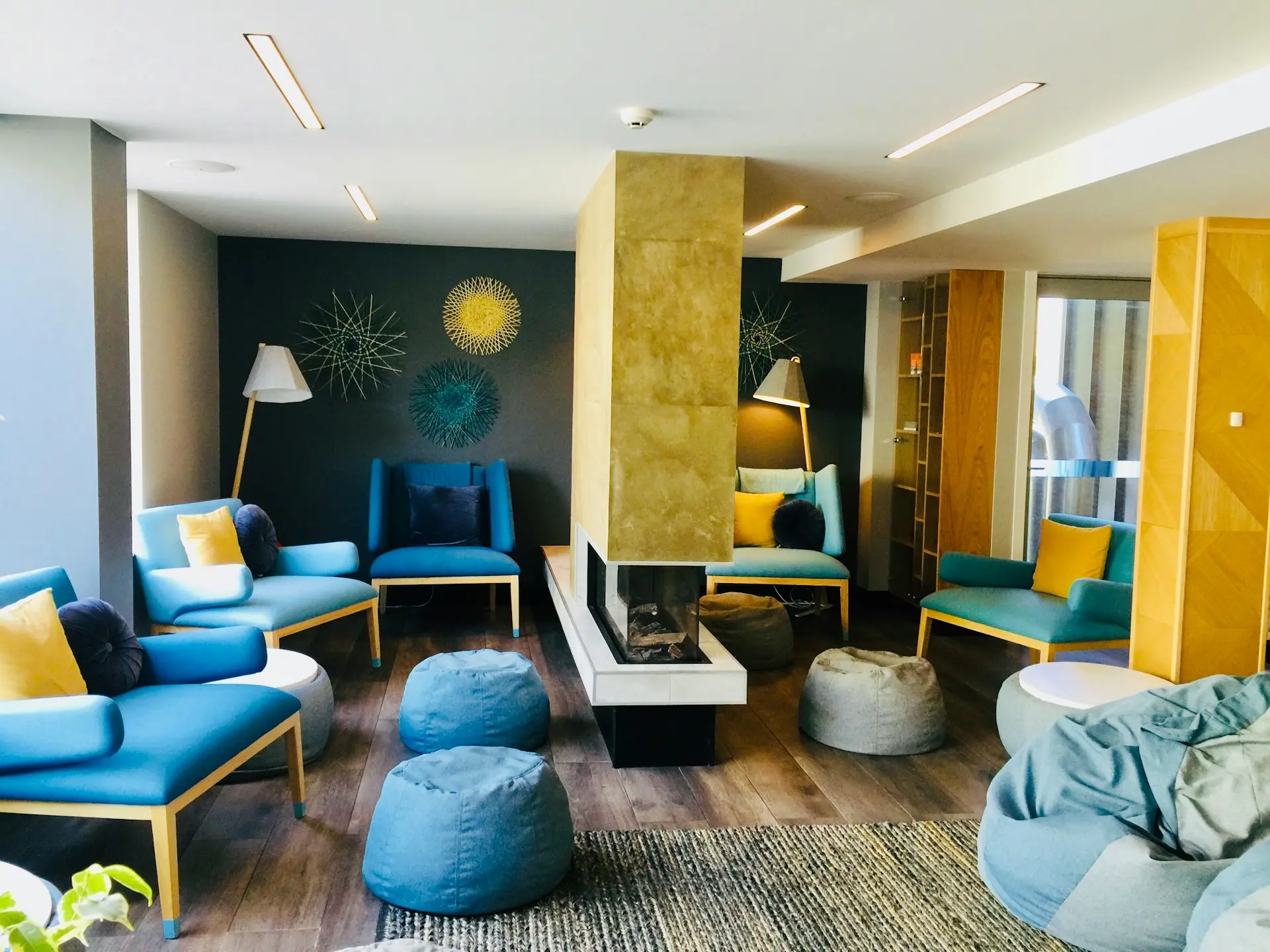 a living room filled with blue and yellow furniture
